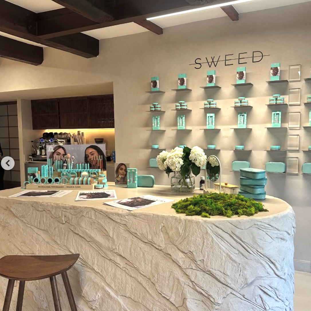 Cosmetic store interior with 'SWEED' branding on shelves.